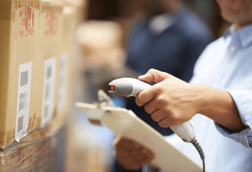 a worker scanning a barcode on a box